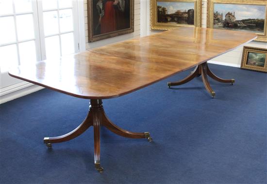 A Regency style twin pillar mahogany extending dining table, Extended 10ft 3in. x 4ft x 2ft 4.5in.